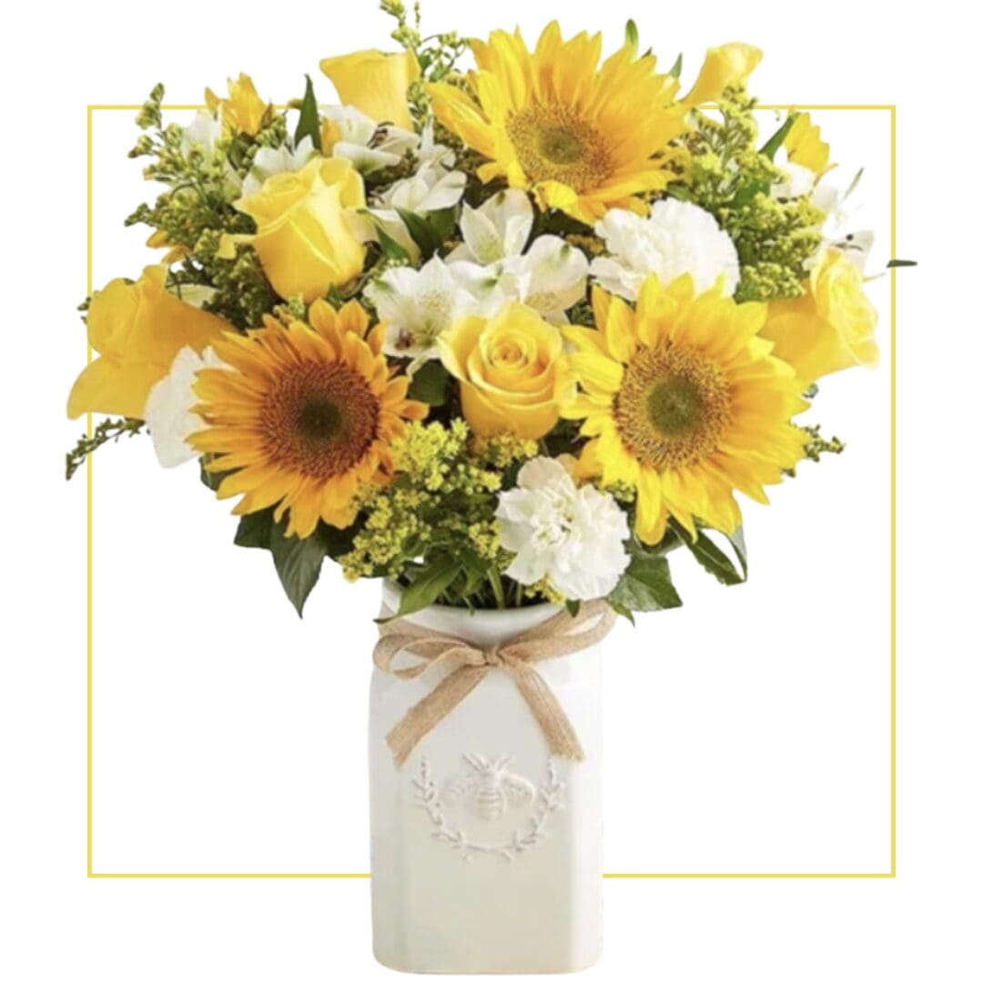 Sunflowers and roses in a white vase.