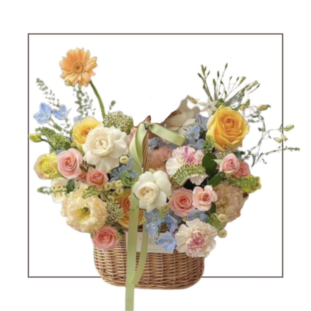 Basket of assorted colorful flowers with ribbon.