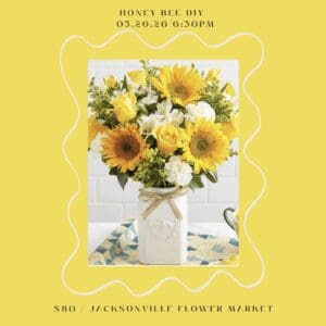 Yellow and white flower bouquet in vase.