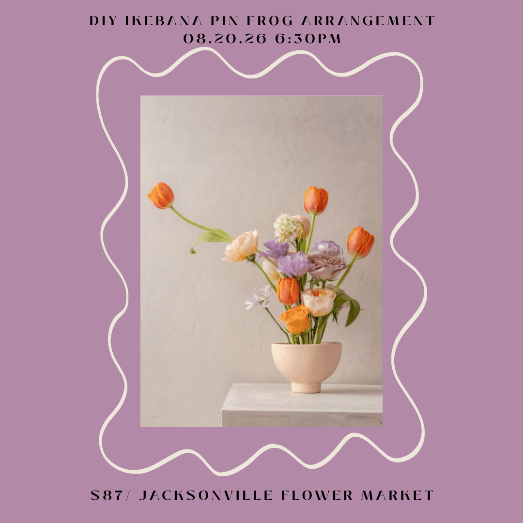 Ikebana floral arrangement with orange tulips