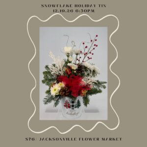 Holiday floral arrangement in decorated tin