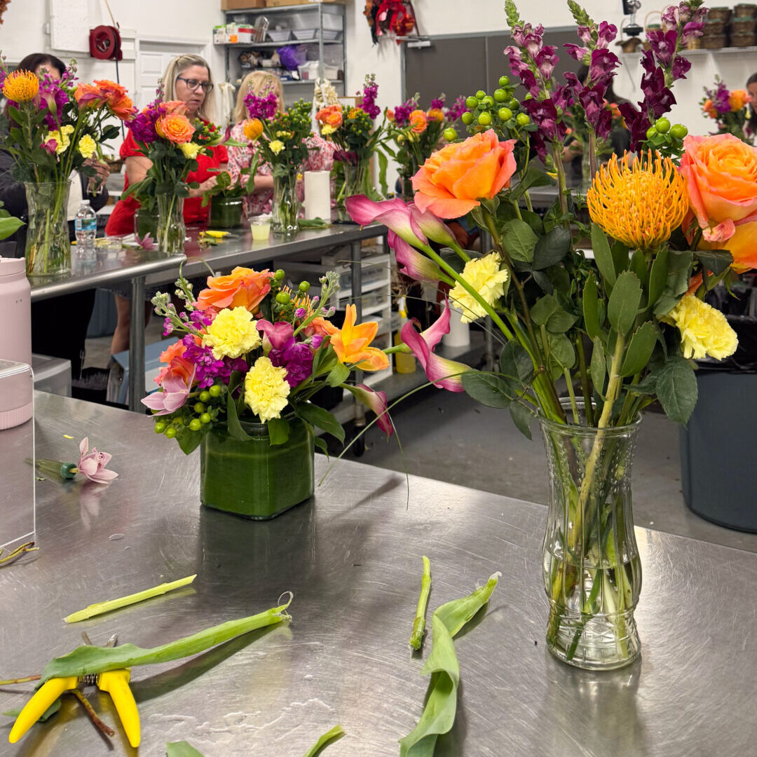 Colorful floral arrangements on metal worktable