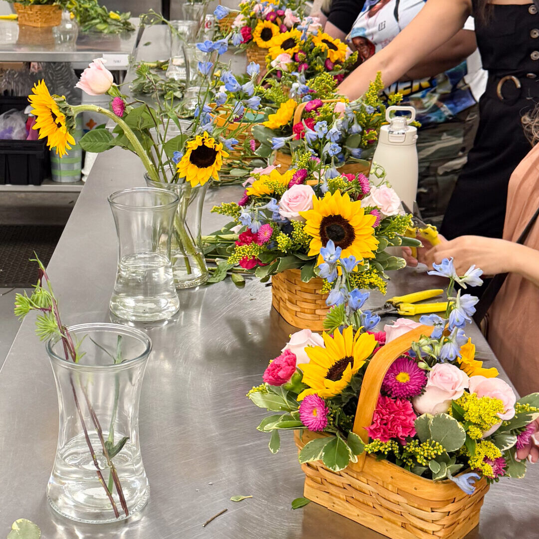 Sunflower bouquets in baskets on stainless table