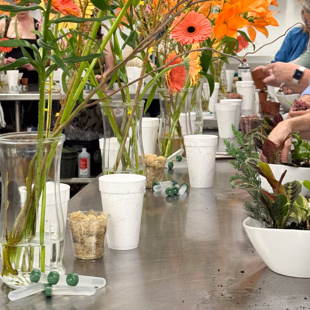 Floral workshop table with orange gerbera daisies
