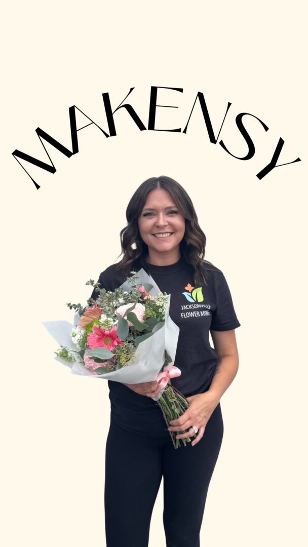 Smiling woman holding bouquet of pink flowers